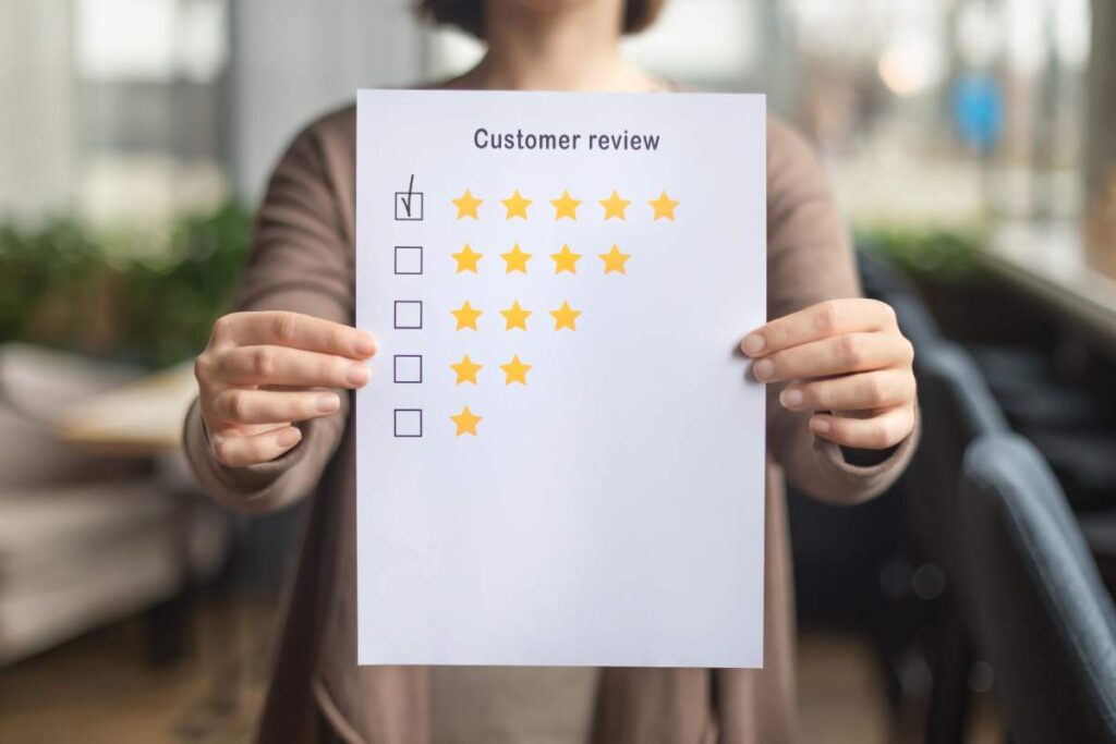 Satisfaction concept. Woman choosing with tick five star rating on paper sheet, blurred background