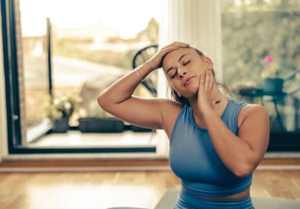 Woman Doing Yoga Stretching Exercises At Home