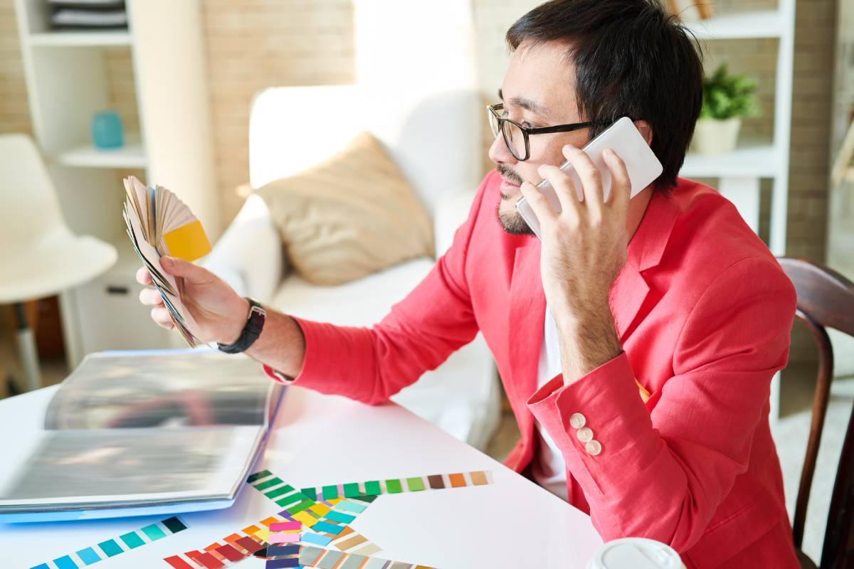 Designer choosing colors and speaking on phone