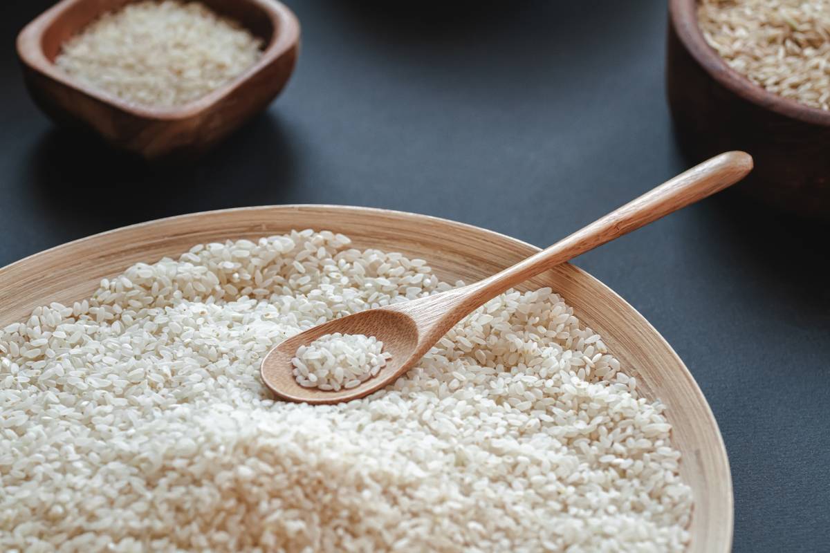 White round rice and cereals in wooden or bamboo spoon