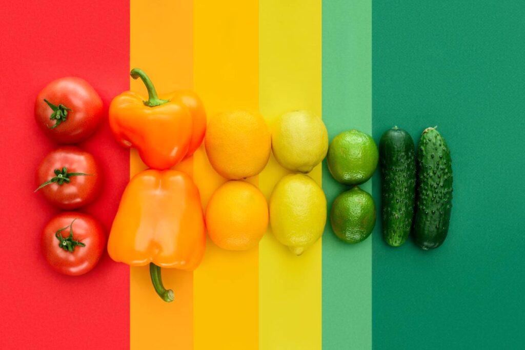 top view of ripe tomatoes, lemons and cucumbers on colored surface