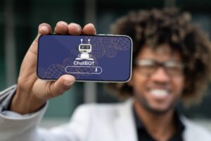 Positive african american entrepreneur showing phone with chatbot