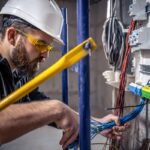 a-male-electrician-works-in-a-switchboard-with-an-2025-03-13-03-09-03-utc (1)