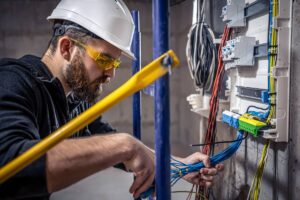 a-male-electrician-works-in-a-switchboard-with-an-2025-03-13-03-09-03-utc (1)