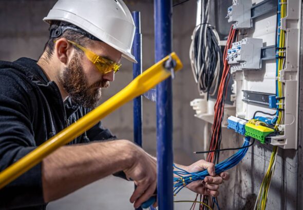 a-male-electrician-works-in-a-switchboard-with-an-2025-03-13-03-09-03-utc (1)